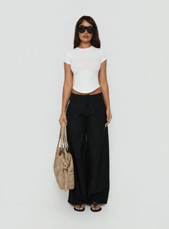 Featuring the Loved Up Low Rise Baggy Pants Black Tall in womens-regular-pants with low-rise waist front view of model wearing Princess Polly