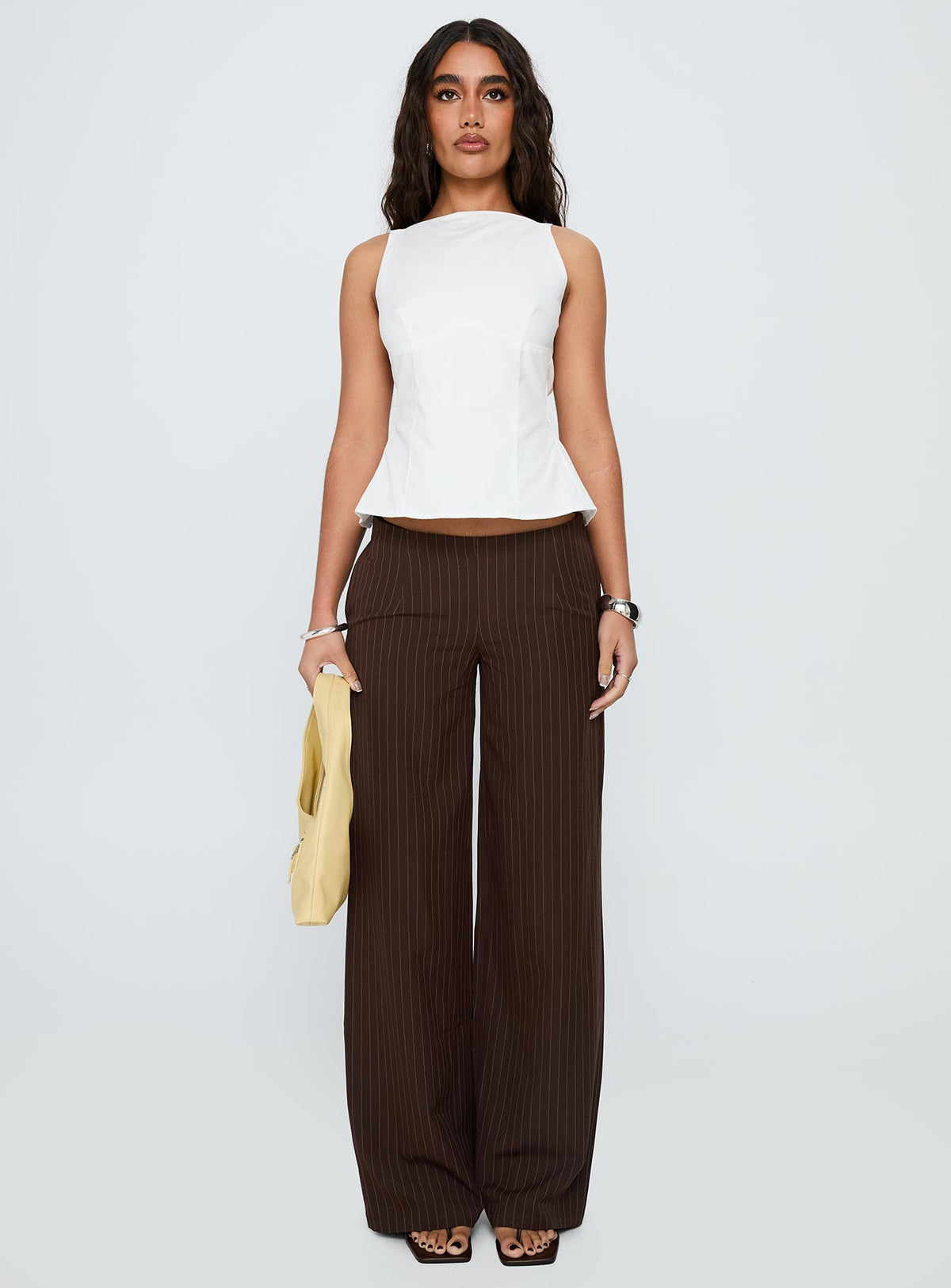 Showcasing Khane Low Rise Wide Leg Pant Brown Pinstripe Petite in womens regular pants front view of model wearing