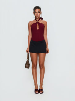 side view of model wearing Princess Polly Bridey Cut Out Bodysuit Red Sleeveless Bodysuit 