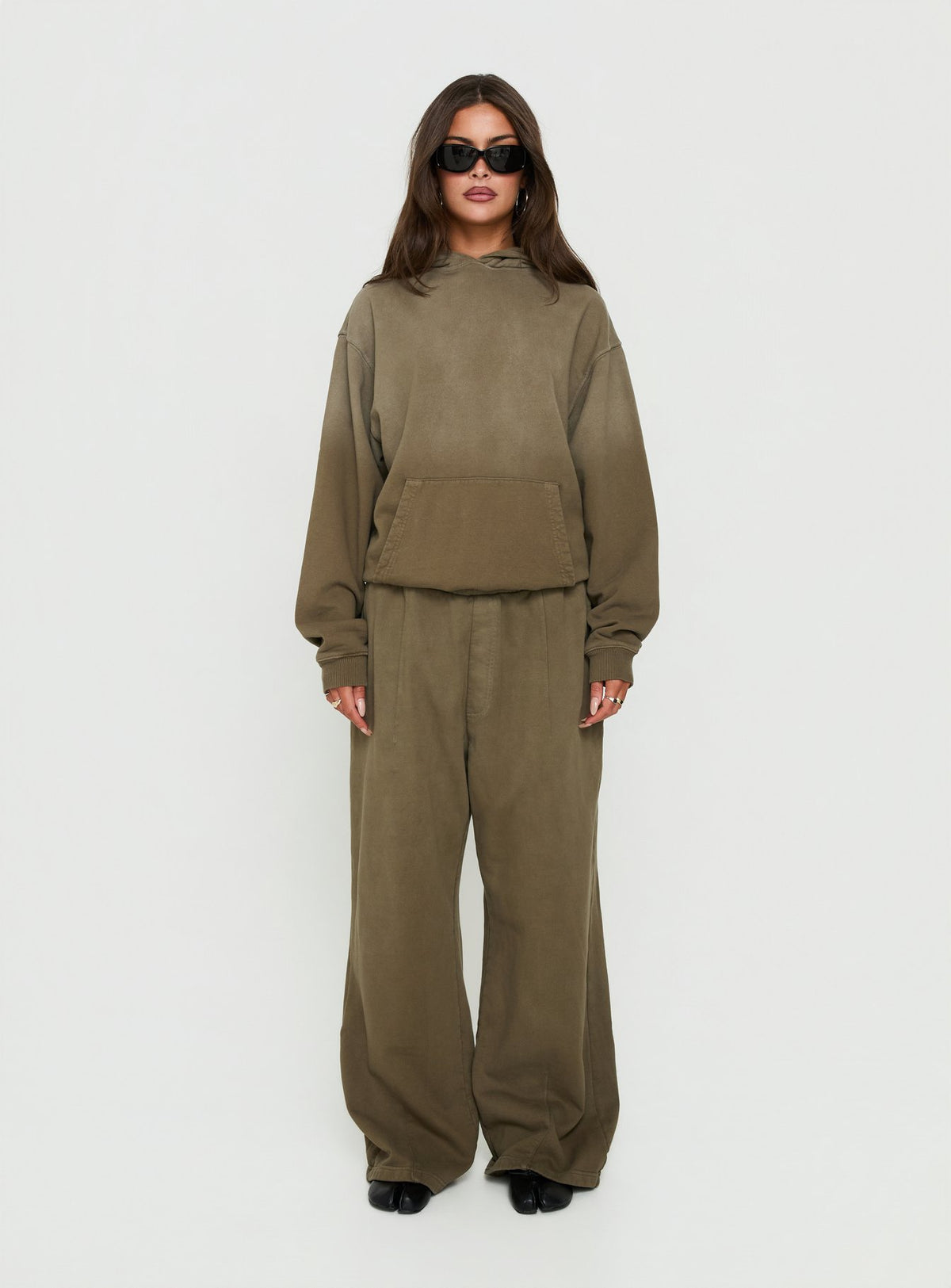 Showcasing the AT Fleece Baggy Sweatpant Washed Olive in womens-regular-pants with mid-rise wide-leg styling front view of model wearing Princess Polly