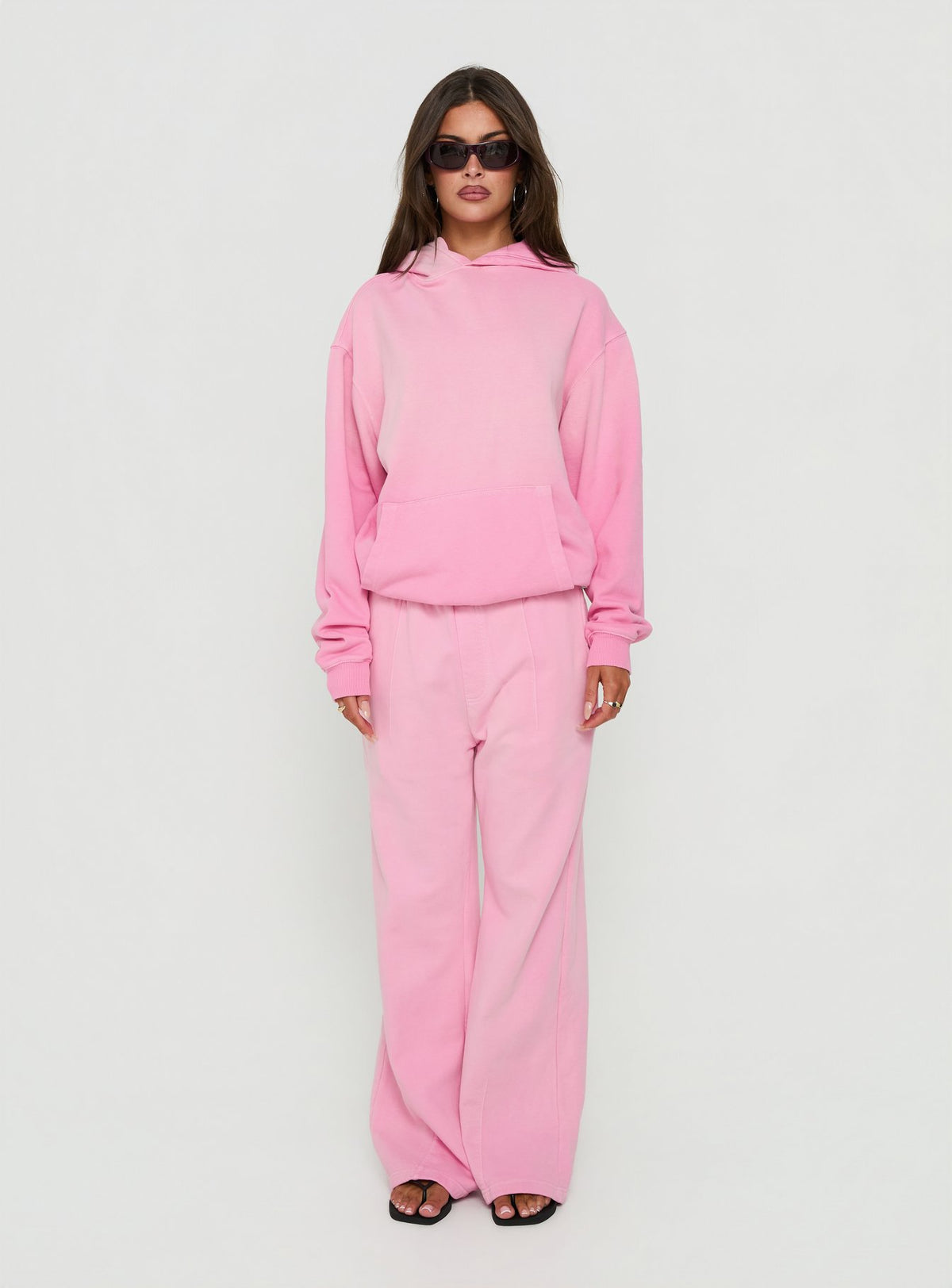Showcasing the AT Fleece Baggy Sweatpant Washed Pink in womens-regular-pants with mid-rise waist front view of model wearing Princess Polly