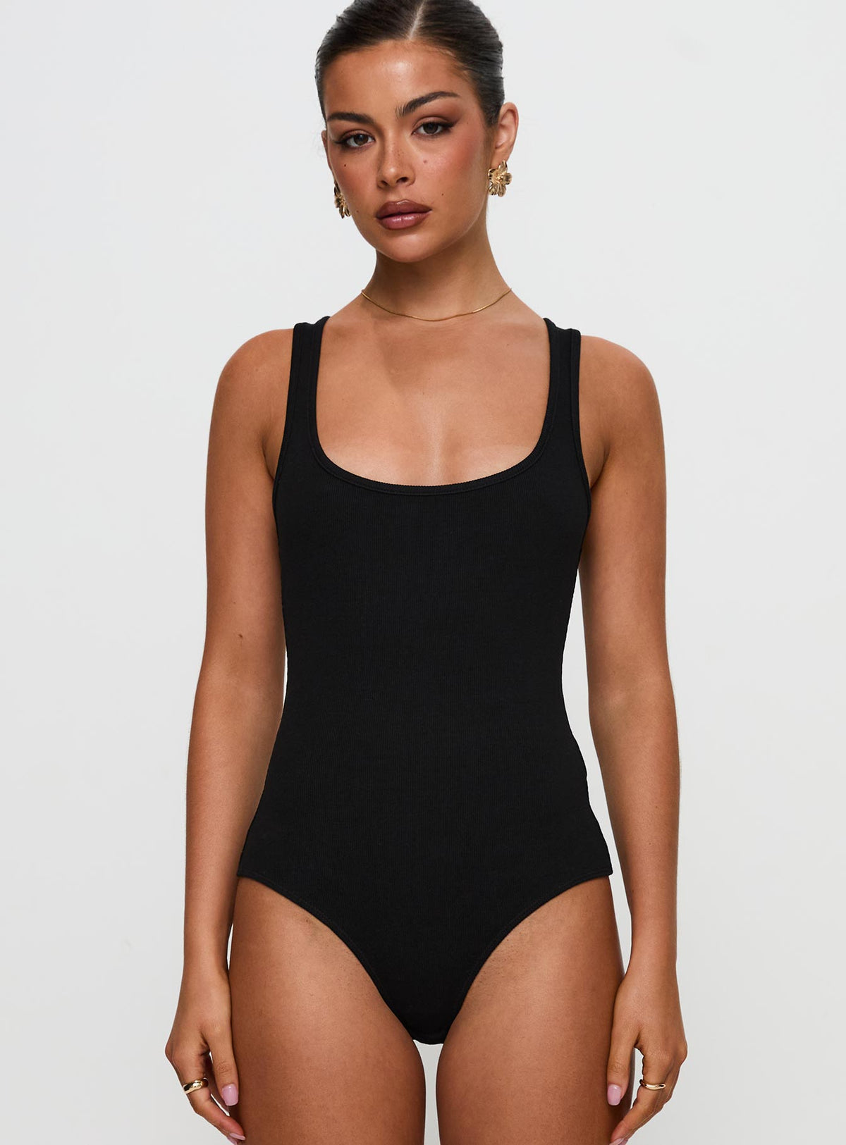 front view of model wearing Princess Polly Baseline Rib Bodysuit Black Sleeveless Bodysuit 