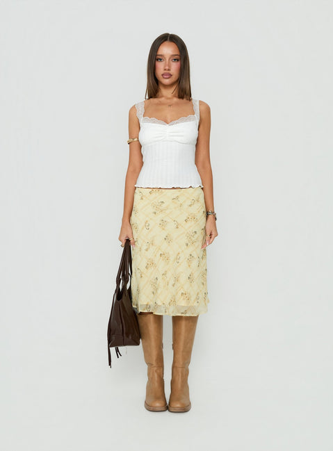 Featuring the Evina Picot Trim Midi Skirt Yellow Paisley womens-skirts with a-line shape, frill details, fitted silhouette, frayed hem, and midi length front view of model wearing Princess Polly