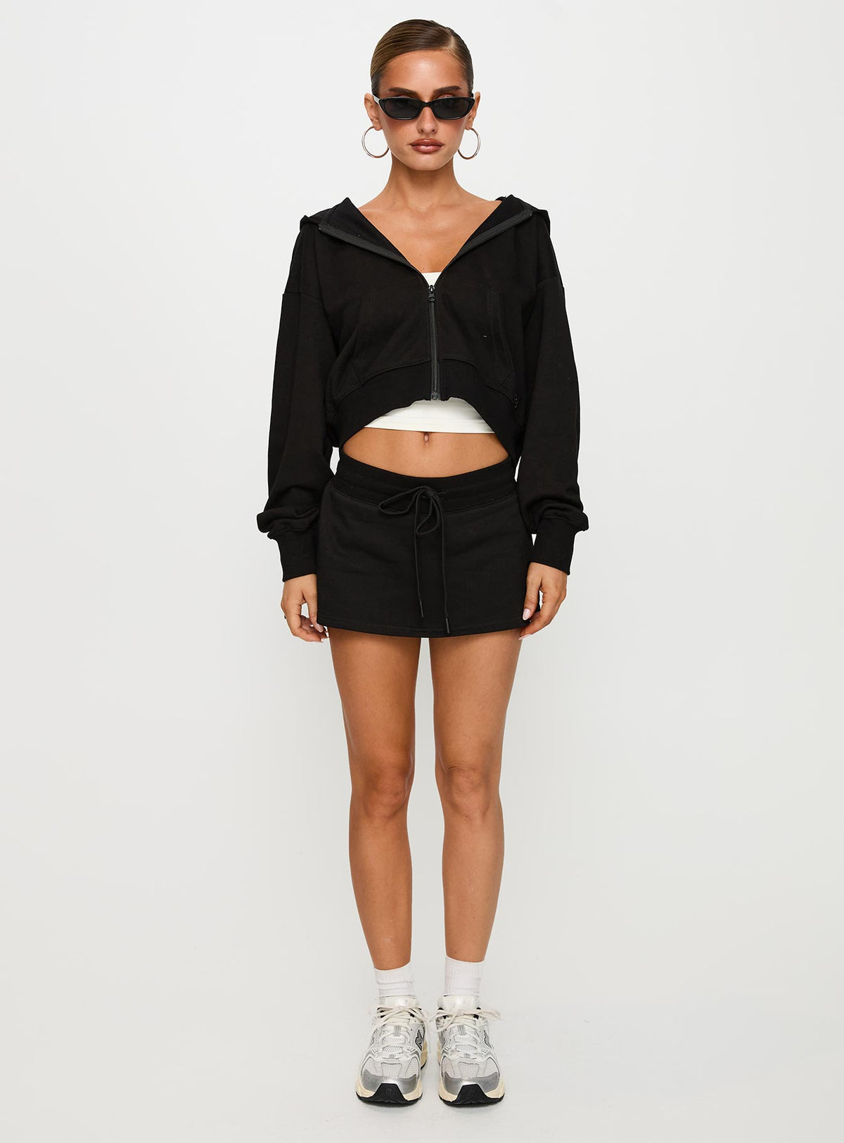 back view of model wearing Princess Polly Down Low Fleece Skort Black Low Rise Shorts 