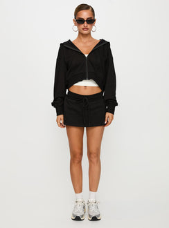 back view of model wearing Princess Polly Down Low Fleece Skort Black Low Rise Shorts 