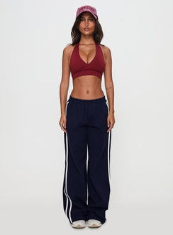 side view of model wearing Princess Polly Circuit Track Pants Navy 
