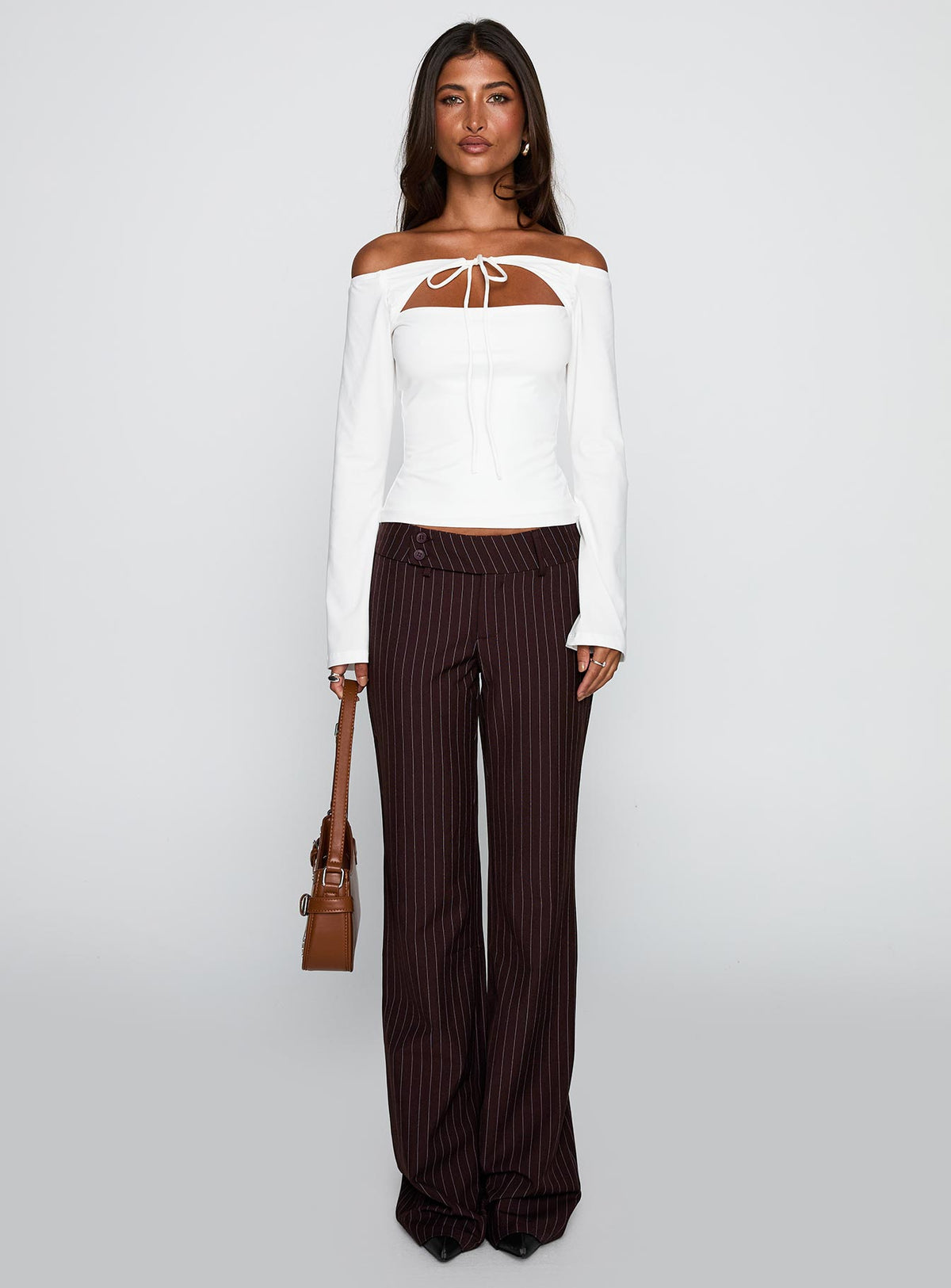 front view of model wearing Princess Polly Kinkirk Flared Pants Brown Pinstripe Low Rise Pants Pants 