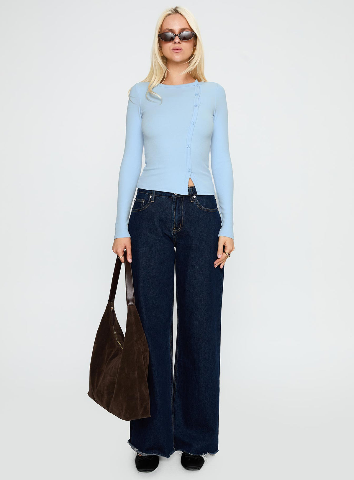 side view of model wearing Princess Polly Passoni Long Sleeve Top Blue Full Sleeves Crew Neck 