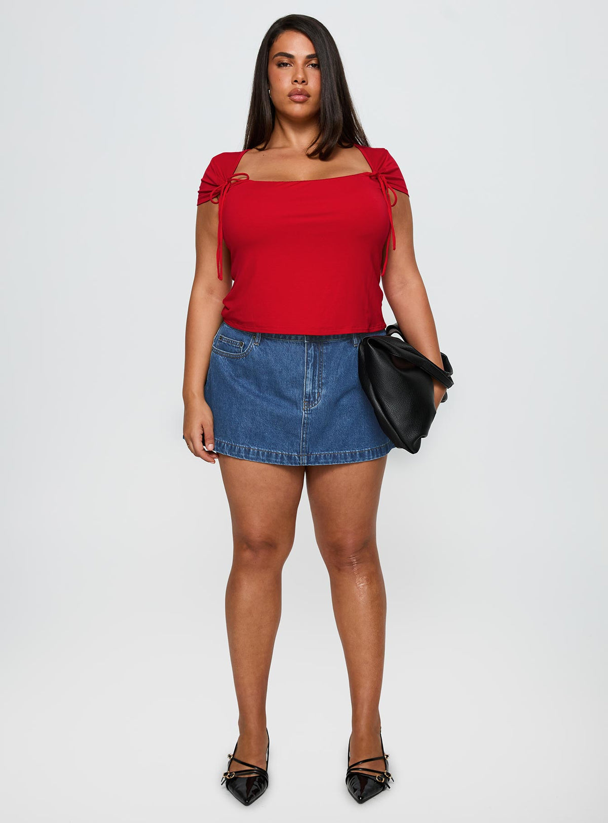   side view of model wearing Princess Polly Nicolina Low Rise Denim Mini Skirt Light Wash Curve Mini Skirts Skirts 