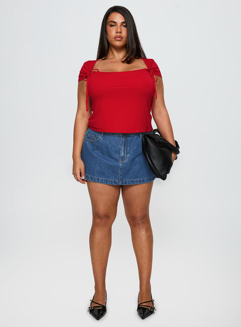   side view of model wearing Princess Polly Nicolina Low Rise Denim Mini Skirt Light Wash Curve Mini Skirts Skirts 