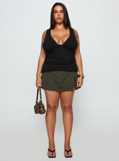 side view of model wearing Princess Polly For The Thrill Skort Green Curve High Waisted Shorts 