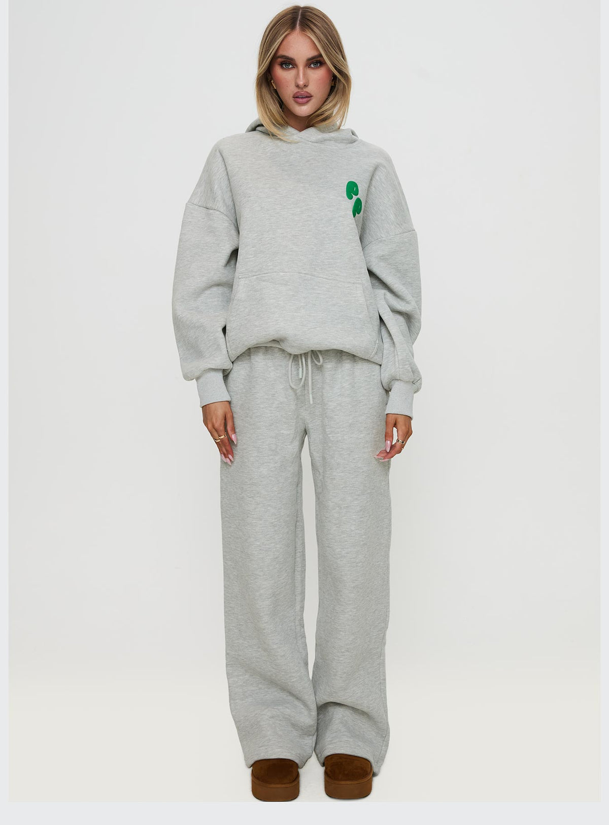 side view of model wearing Princess Polly Princess Polly Hooded Sweatshirt Bubble Text Grey Marle / Green Jumpers 