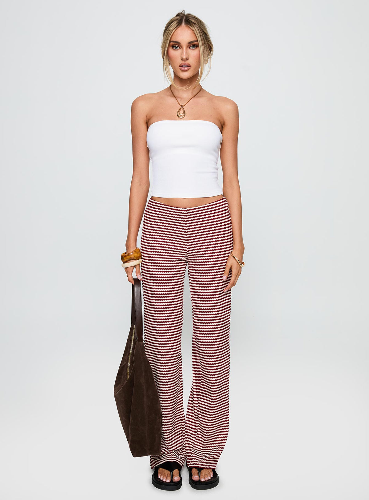 side view of model wearing Princess Polly Next To Me Lounge Pant Red / White Stripe Low Rise Pants Pants 