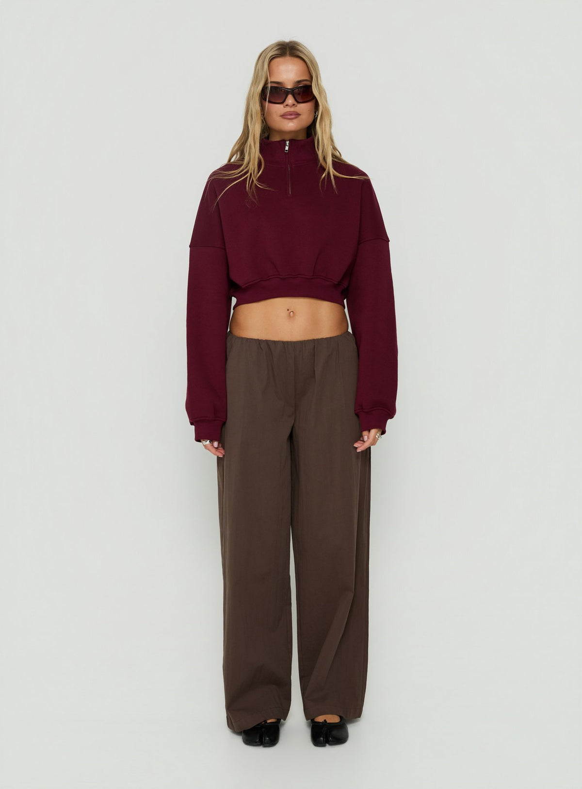 Showcasing the Astridd 3/4 Zip Cropped Jumper Cherry womens-jumpers with short length front view of model wearing Princess Polly
