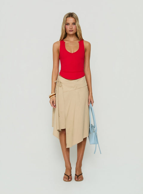 Discover the Ellainah Asymmetrical Wrap Midi Skirt Concrete in tan front view of model wearing Princess Polly