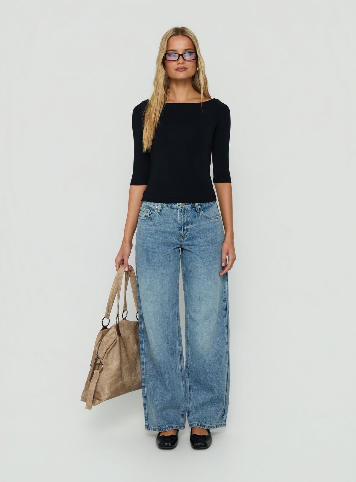 Showcasing Serenitia Mid Rise Relaxed Jeans in Bright Blue womens-jeans with mid-rise waist front view of model wearing