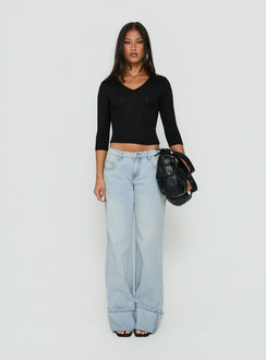 Showcasing Ezia Wide Cuff Baggy Jeans Light Blue Wash in womens-jeans with high-rise front view of model wearing Princess Polly