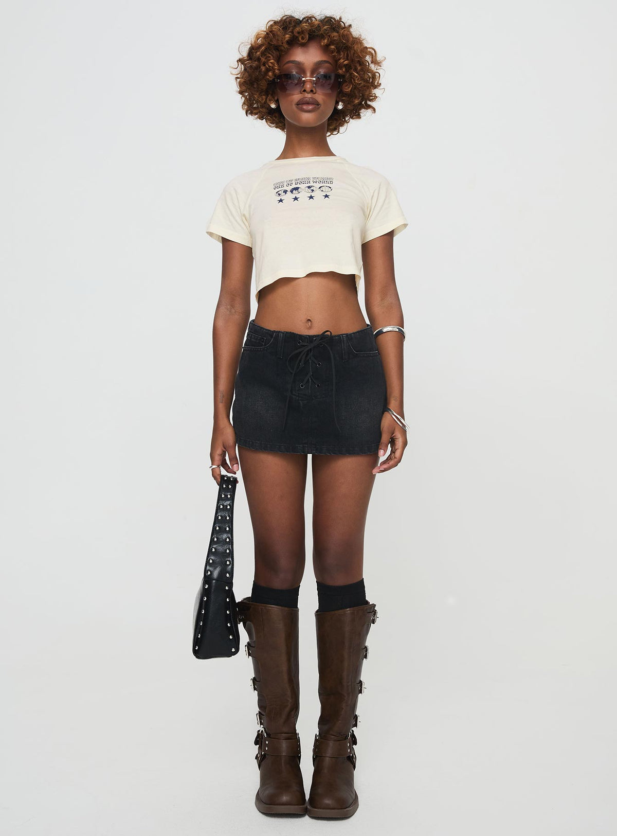 side view of model wearing Princess Polly Amethysta Denim Skort Black Low Rise Shorts 