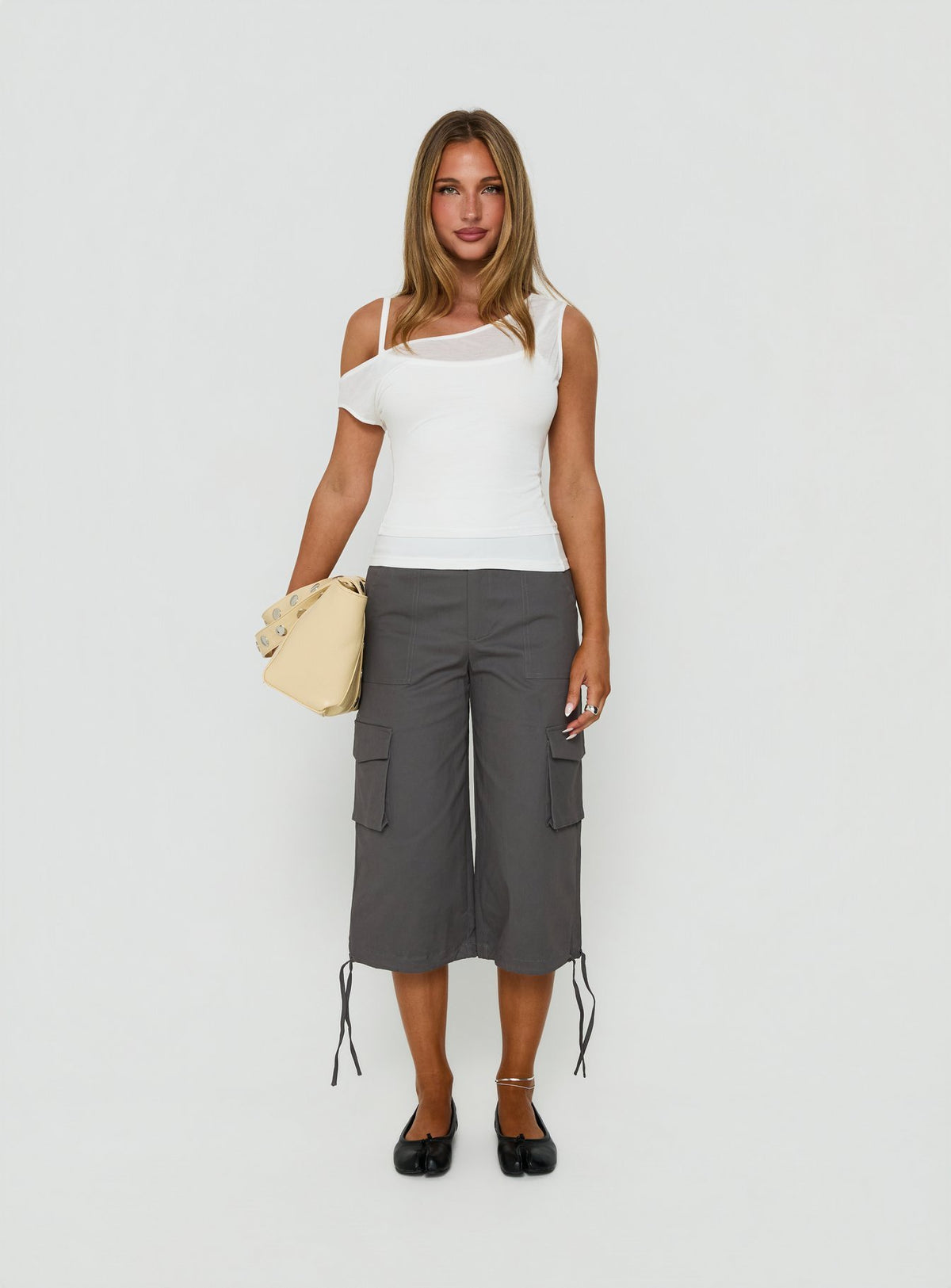 Featuring the Alfonza Utility Capri in Slate womens-regular-pants with mid-rise cargo styling front view of model wearing Princess Polly