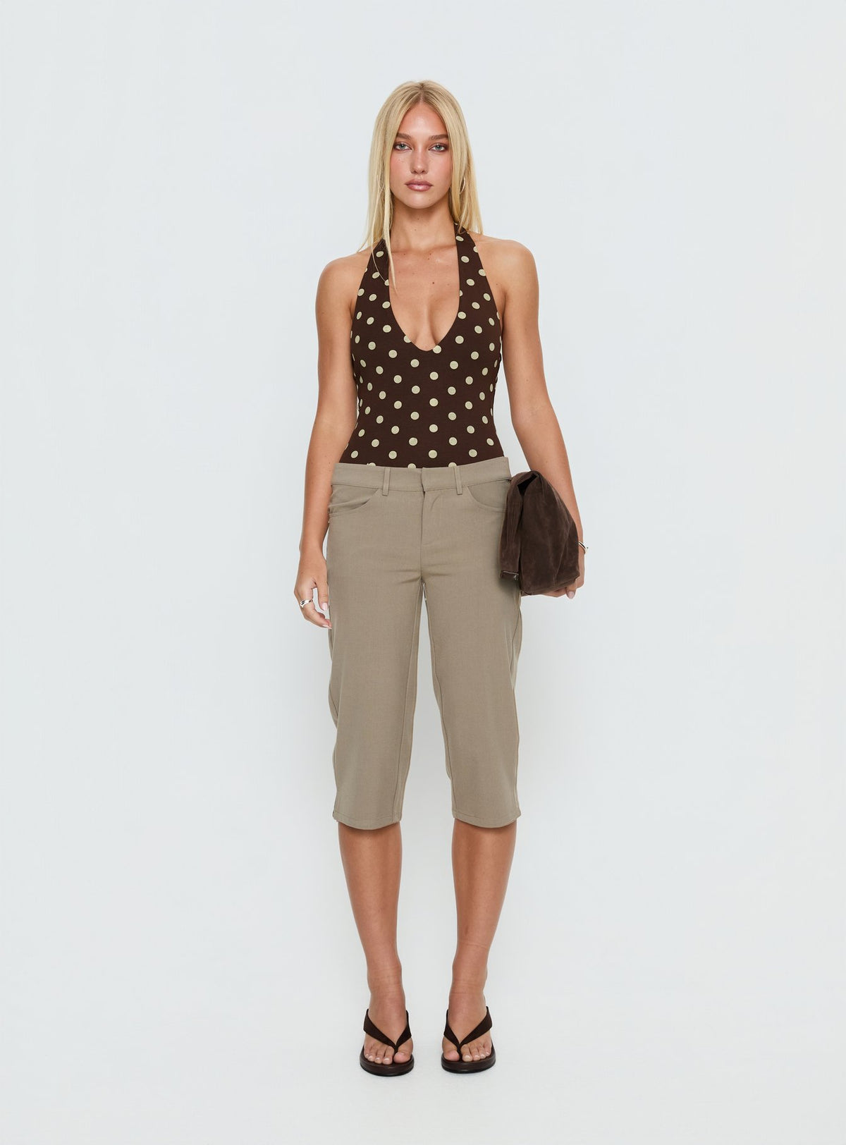 side view of model wearing Princess Polly Someone New Halter Bodysuit Chocolate Polka Sleeveless Bodysuit 
