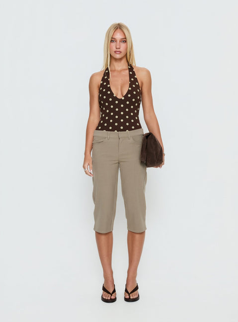 side view of model wearing Princess Polly Someone New Halter Bodysuit Chocolate Polka Sleeveless Bodysuit 