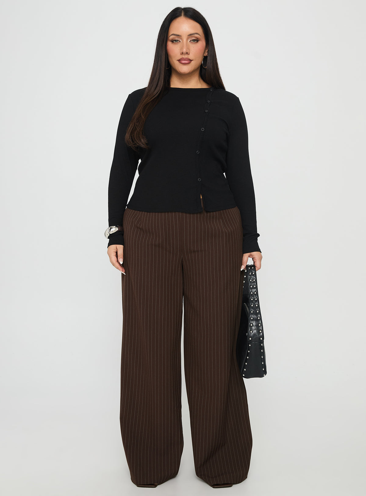 side view of model wearing Princess Polly Khane Low Rise Wide Leg Pant Brown Pinstripe Curve Low Rise Pants Pants 