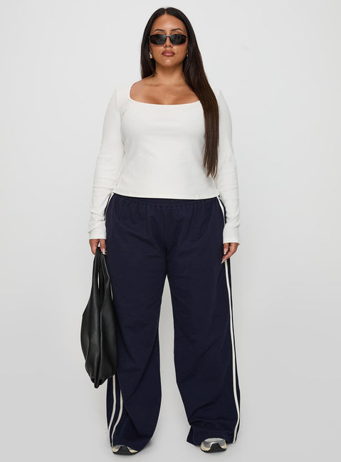 front view of model wearing Princess Polly Circuit Track Pants Navy Curve Pants 