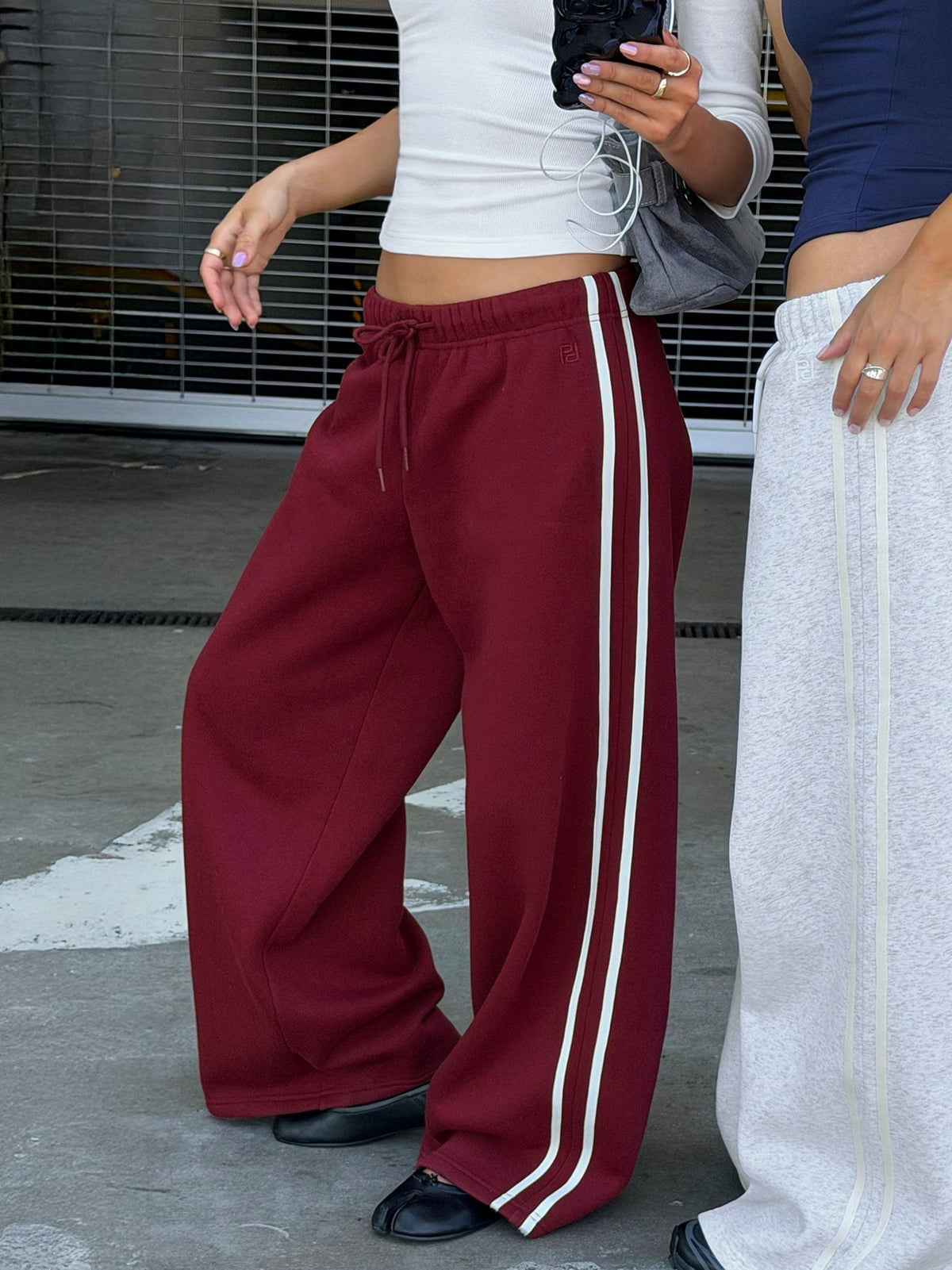 Crafted from cherry fabric, the Kennah Wide Leg Sweat Pants in womens-regular-pants with mid-rise waist front view of model wearing Princess Polly