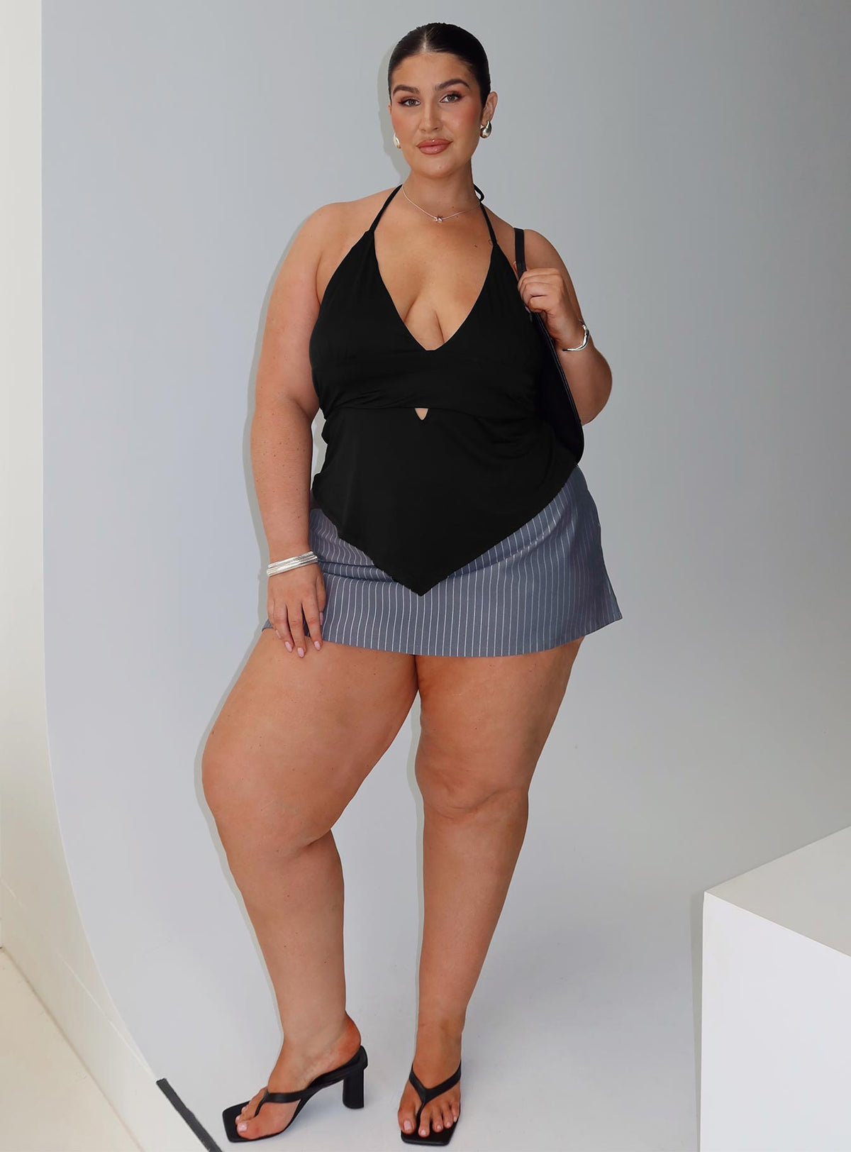 front view of model wearing Princess Polly Averee Halter Top Black Curve Sleeveless Plunger 