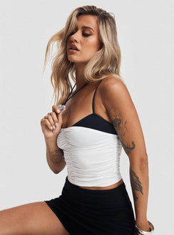 side view of model wearing Princess Polly Vickee Top White / Black Sleeveless Scoop Neck 