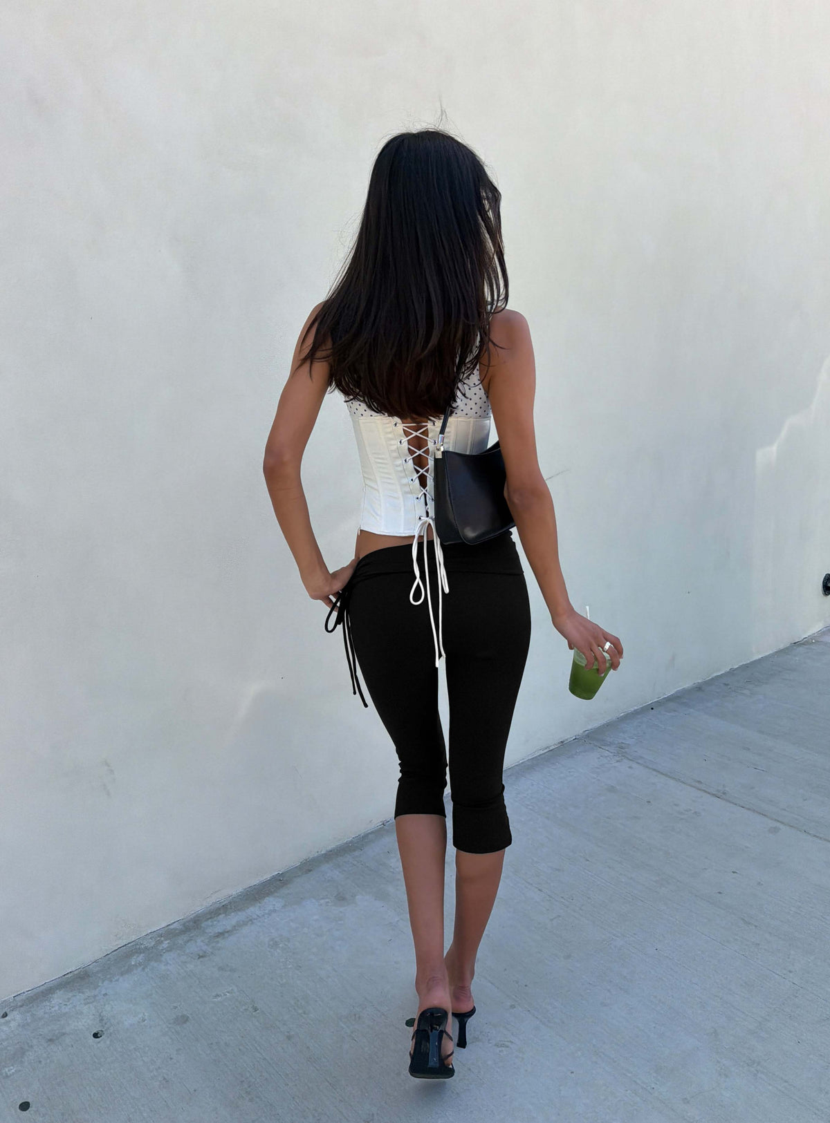 Presenting the Bailor Channel Waistband Capri Pants Black in womens-regular-pants with high-rise and ruched slim design back view of model wearing Princess Polly