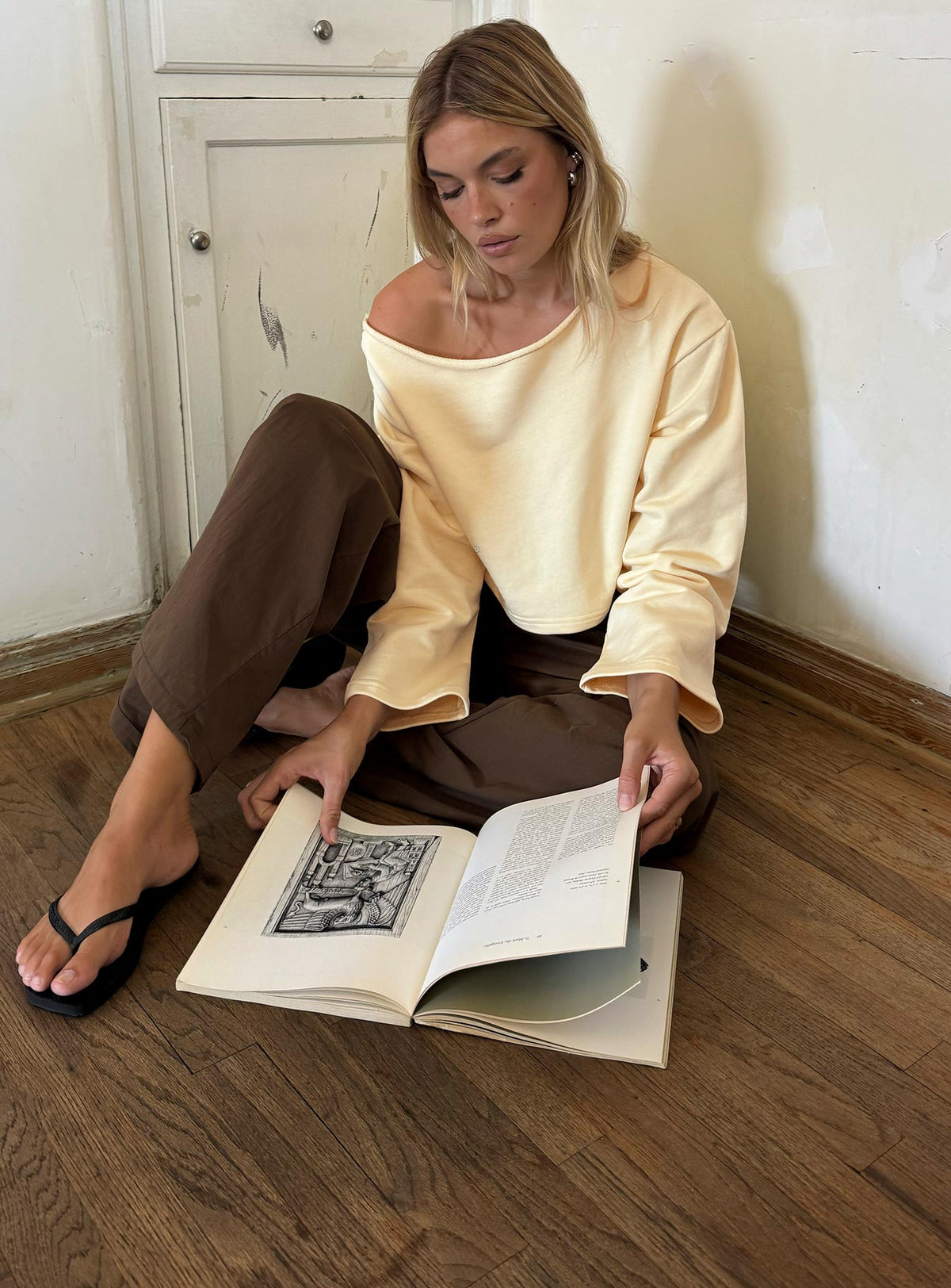 Showcasing the Retreat Raw Edge Off Shoulder Jumper Buttercream womens-jumpers with short length front view of model wearing Princess Polly