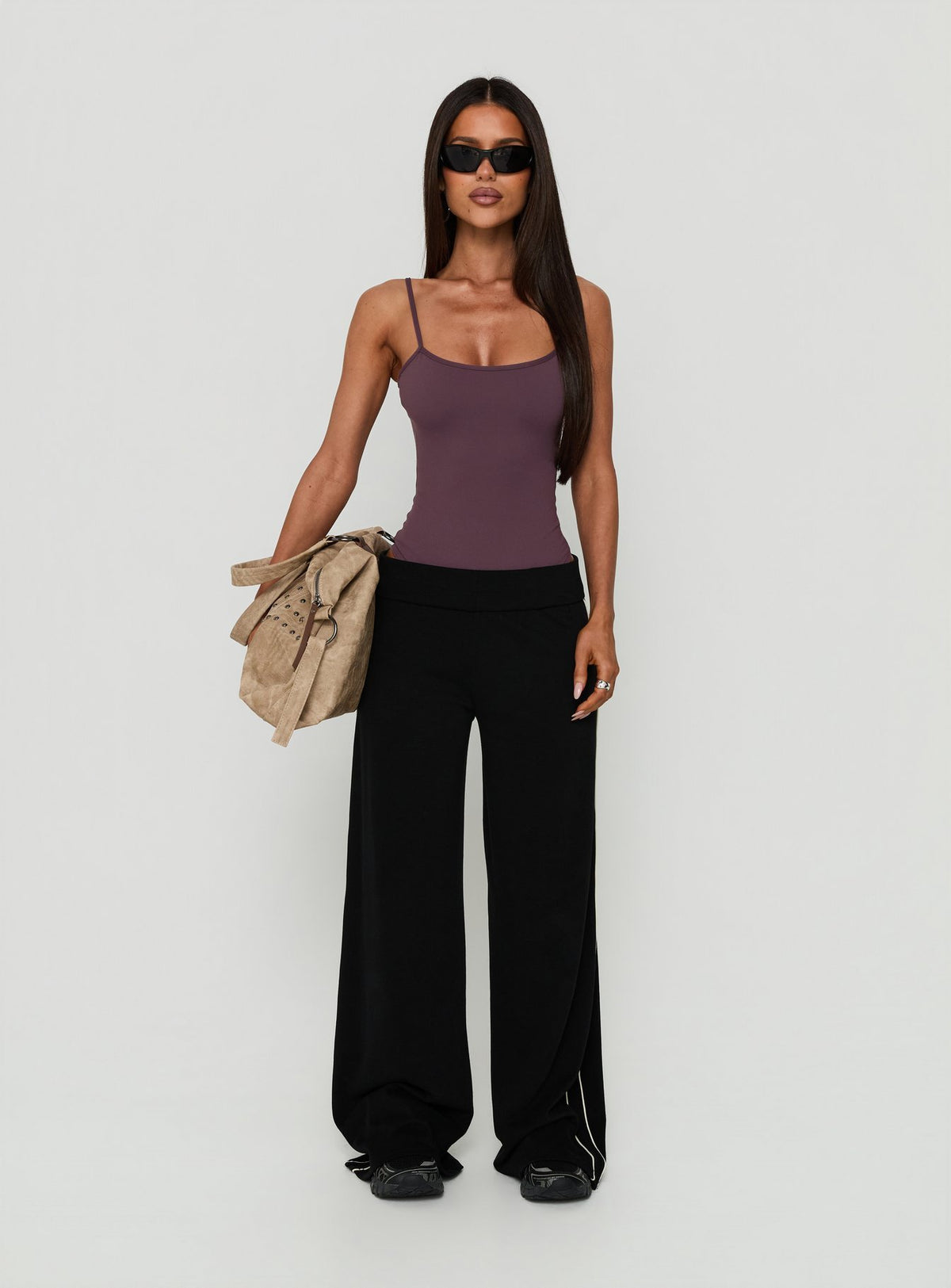 Showcasing the Daily Define Thin Strap Low Back Bodysuit Aubergine womens-bodysuit with sleeveless design product view of model wearing