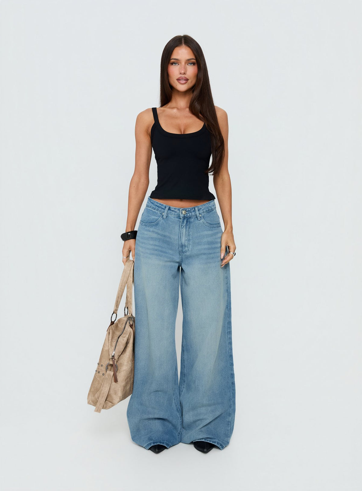 Showcasing the Naylor Mid Rise Wide Leg Jeans Light Wash Denim Tall in womens-jeans with mid-rise front view of model wearing Princess Polly