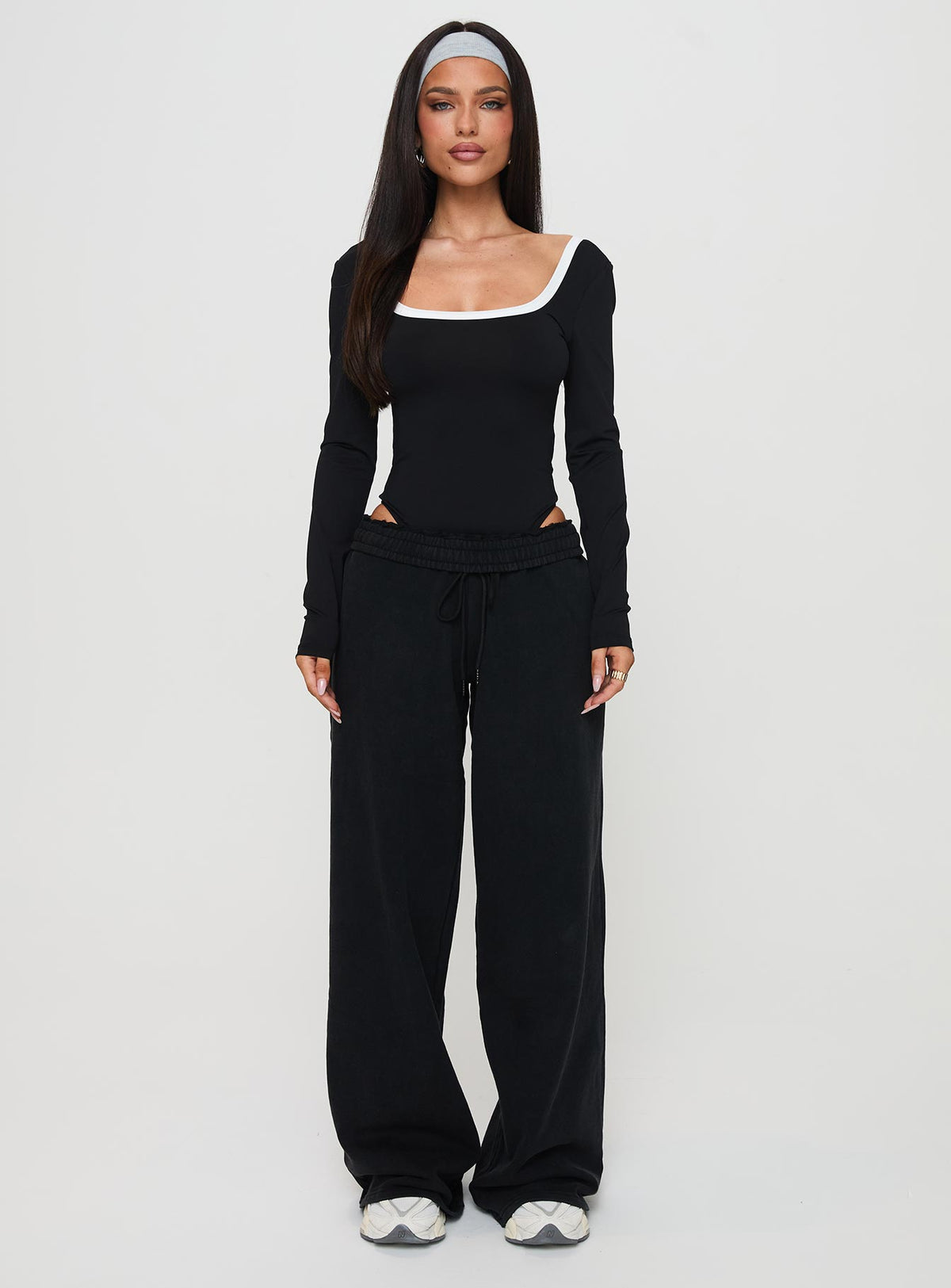side view of model wearing Princess Polly Ender Contrast Trim Bodysuit Black Long Sleeve Tops Bodysuit 