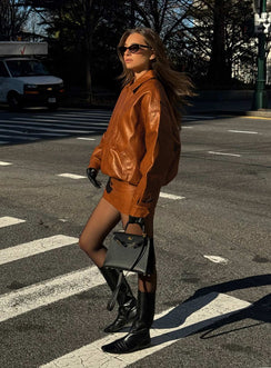 Faux leather bomber jacket Classic collar, zip & button fastening down front, twin hip pockets with press button fastening, elasticated waistband, single button cuff Non-stretch material, fully lined