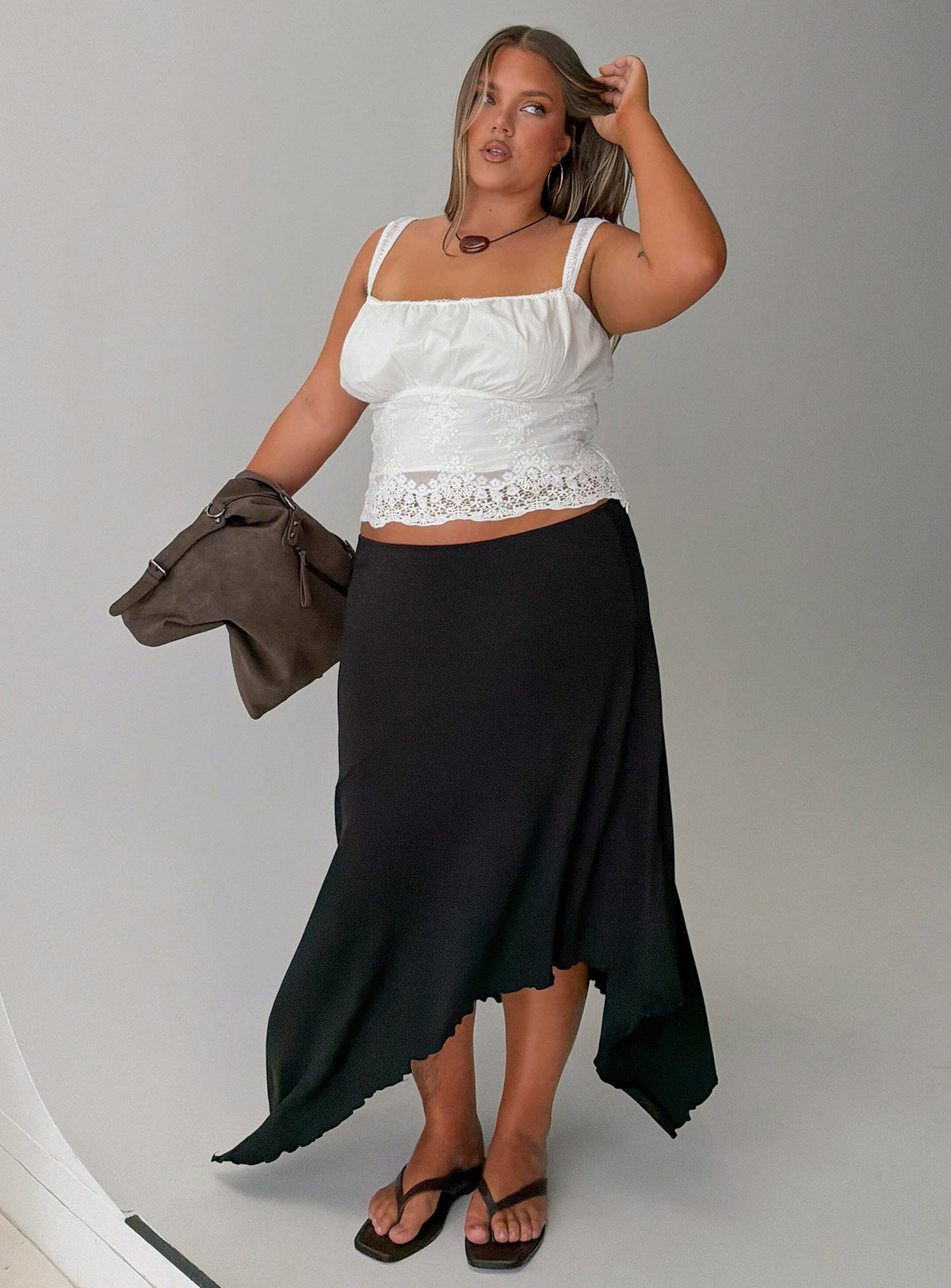 Showcasing the Futura Asymmetrical Midi Skirt Black Curve in womens-skirts with midi length Princess Polly