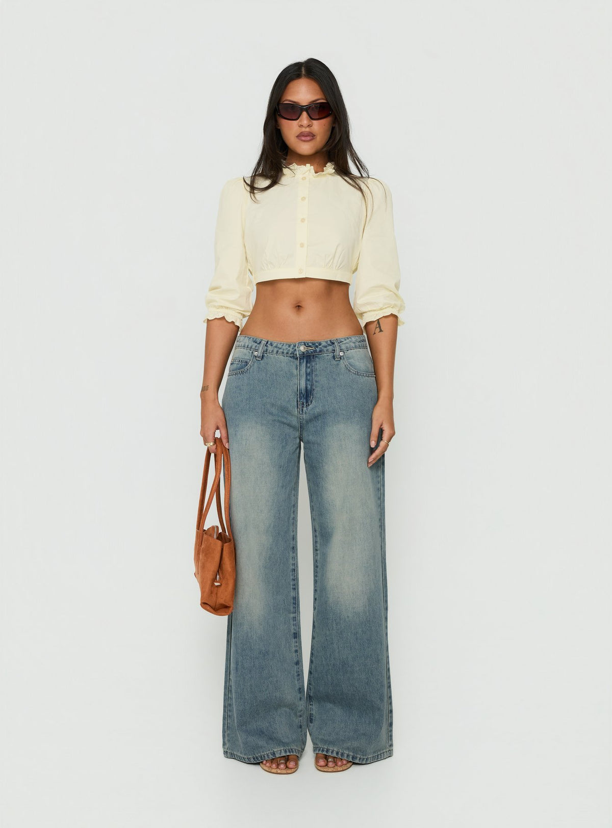 Discover the Karlos Low Rise Cinched Baggy Jeans Vintage Mid Blue Wash in womens-jeans featuring abstract print front view of model wearing Princess Polly