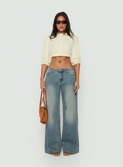 Discover the Karlos Low Rise Cinched Baggy Jeans Vintage Mid Blue Wash in womens-jeans featuring abstract print front view of model wearing Princess Polly