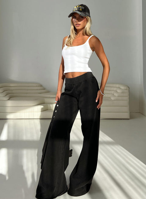 side view of model wearing Princess Polly Summits Flared Track Pants Washed Black High Rise Pants Pants 