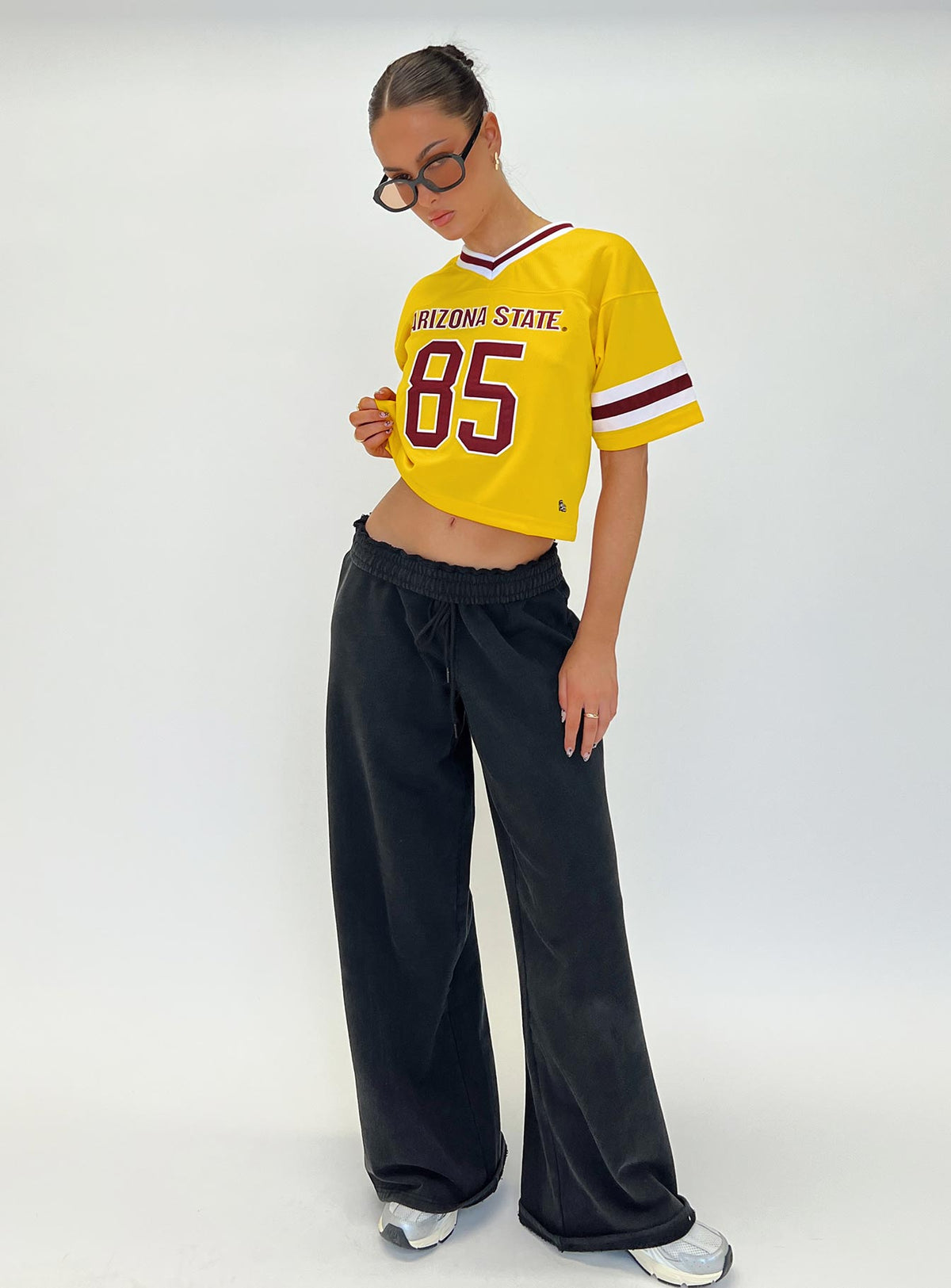 side view of model wearing Princess Polly ASU Football Jersey Gold Half Sleeves V-Neck 