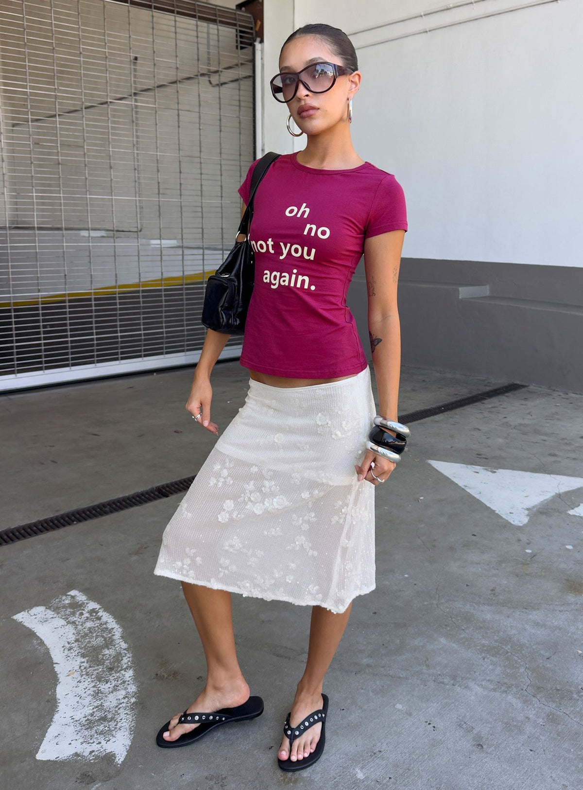 Showcasing the Heart Stealer Sheer Sequin Midi Skirt in White with fitted a-line shape and frayed hem front view of model wearing Princess Polly