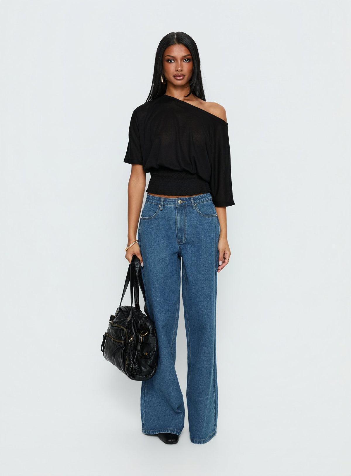 side view of model wearing Princess Polly Naylor Mid Rise Wide Leg Jeans Mid Blue Wash Mid Rise Jeans Jeans 