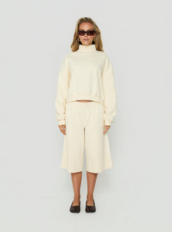 Showcasing the Anyya Funnel Neck Crew Jumper Cream in a short womens jumper front view of model wearing Princess Polly