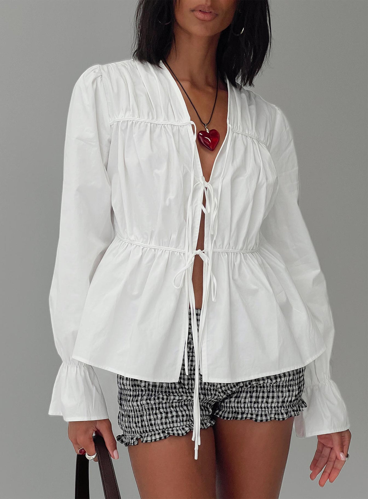 front view of model wearing Princess Polly Scarlotte Bow Tie Top White Full Sleeves V-Neck 