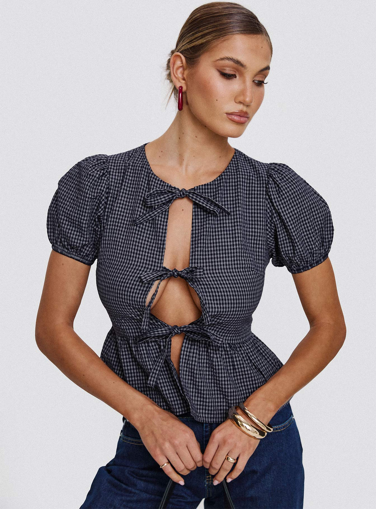 front view of model wearing Princess Polly Verah Tie Up Puff Sleeve Top Navy Check Short Sleeves Scoop Neck 
