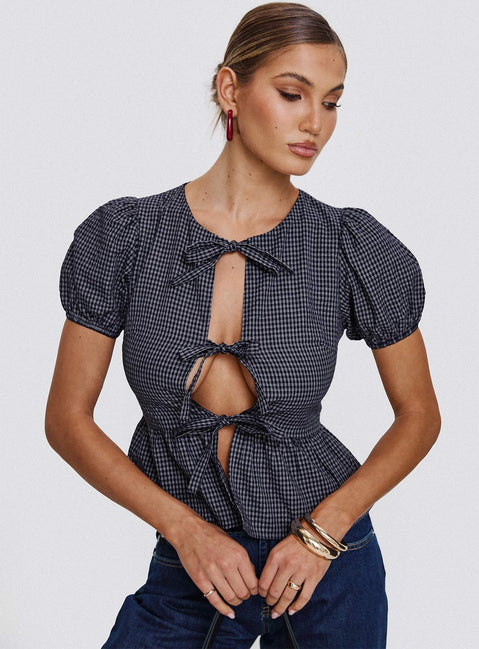 front view of model wearing Princess Polly Verah Tie Up Puff Sleeve Top Navy Check Short Sleeves Scoop Neck 