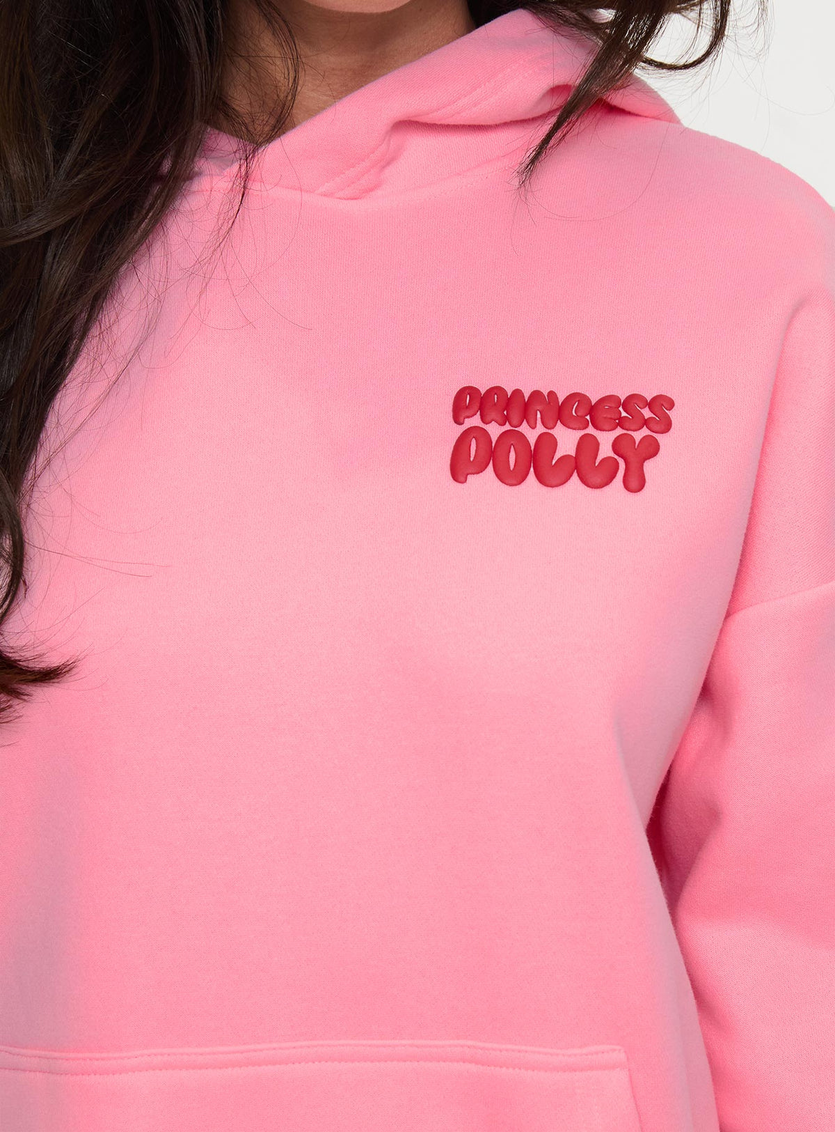 side view of model wearing Princess Polly Princess Polly Hooded Sweatshirt Bubble Text Pink / Red Longline Jumpers Jumpers 