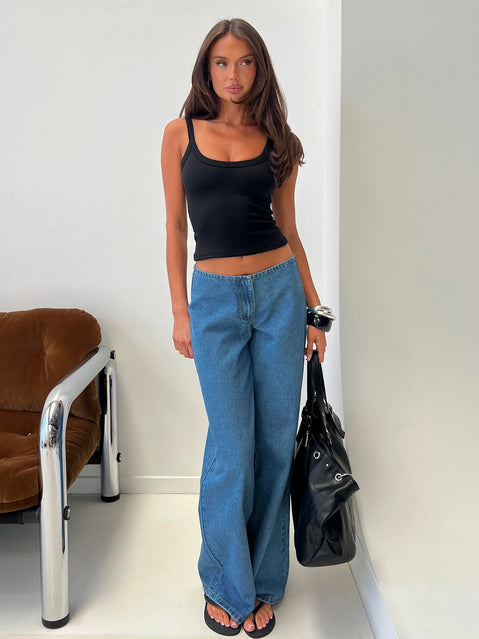 Showcasing the Hereos Mid Rise Baggy Leg Jeans in Bright Blue Wash, womens jeans with mid-rise waist and belt detail, front view of model wearing Princess Polly