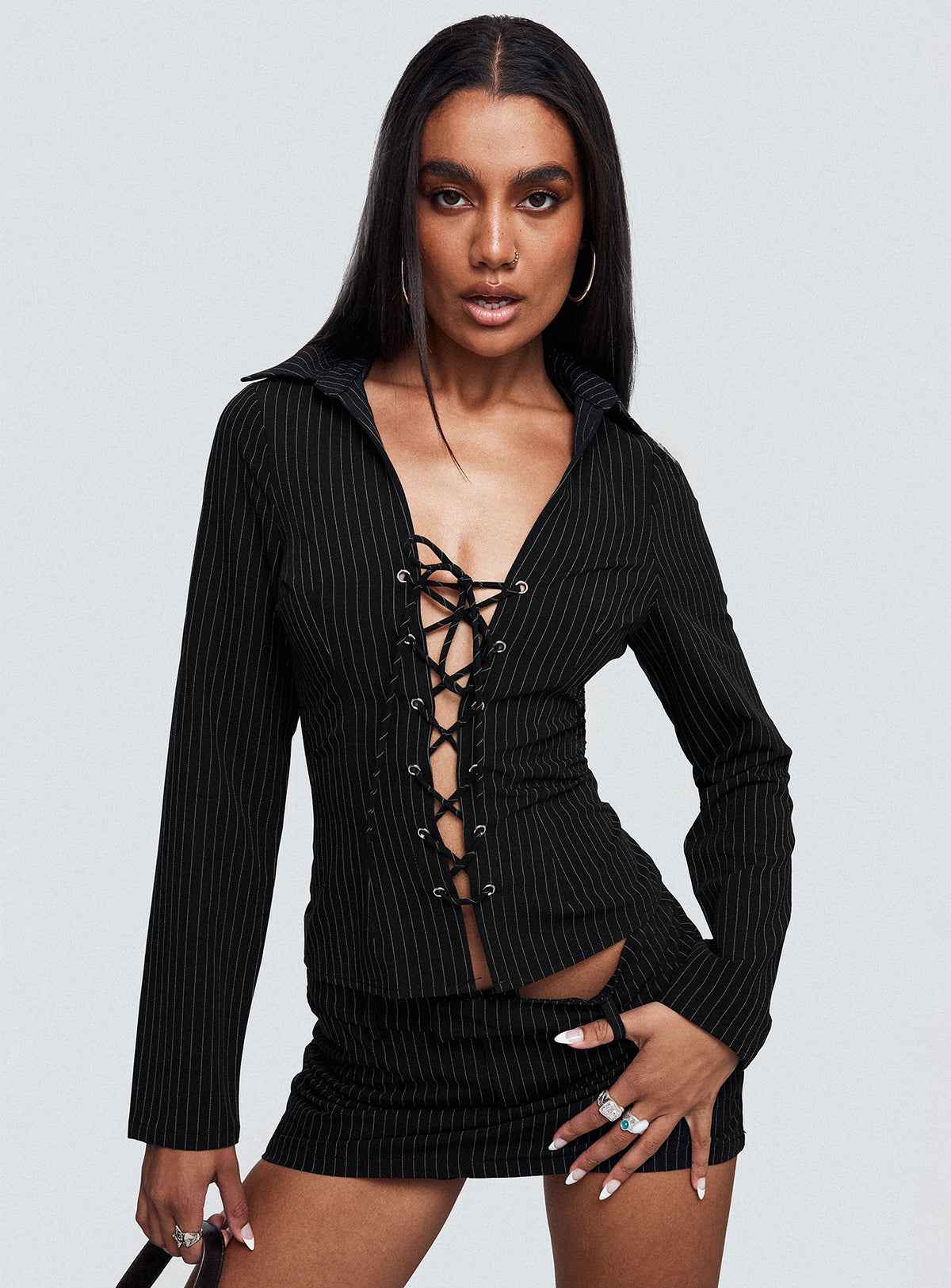 front view of model wearing Princess Polly Feminique Skort Black Stripe High Waisted Shorts 